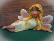 Hand painted ceramic laying down fairy
